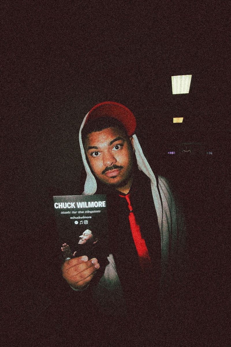 Chuck Wilmore holding a Music for the Kingdom poster